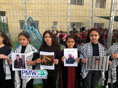 Schoolchildren holding up pictures of terrorists
