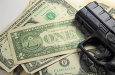 Image of gun and dollars representing Pay-for-Slay